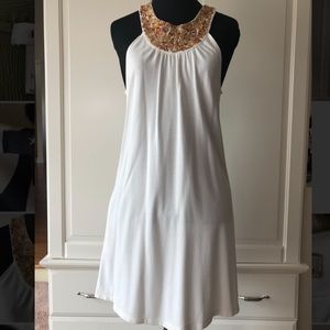 Women’s white sleeveless dress with embroidery neckline design